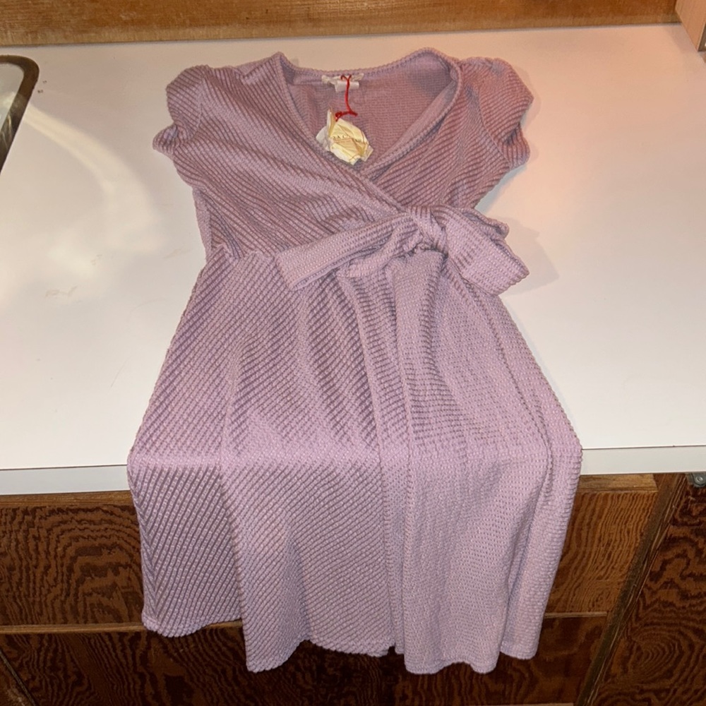 Brand new purple / mauve ish color dress with bow! Crossover deep neck line.